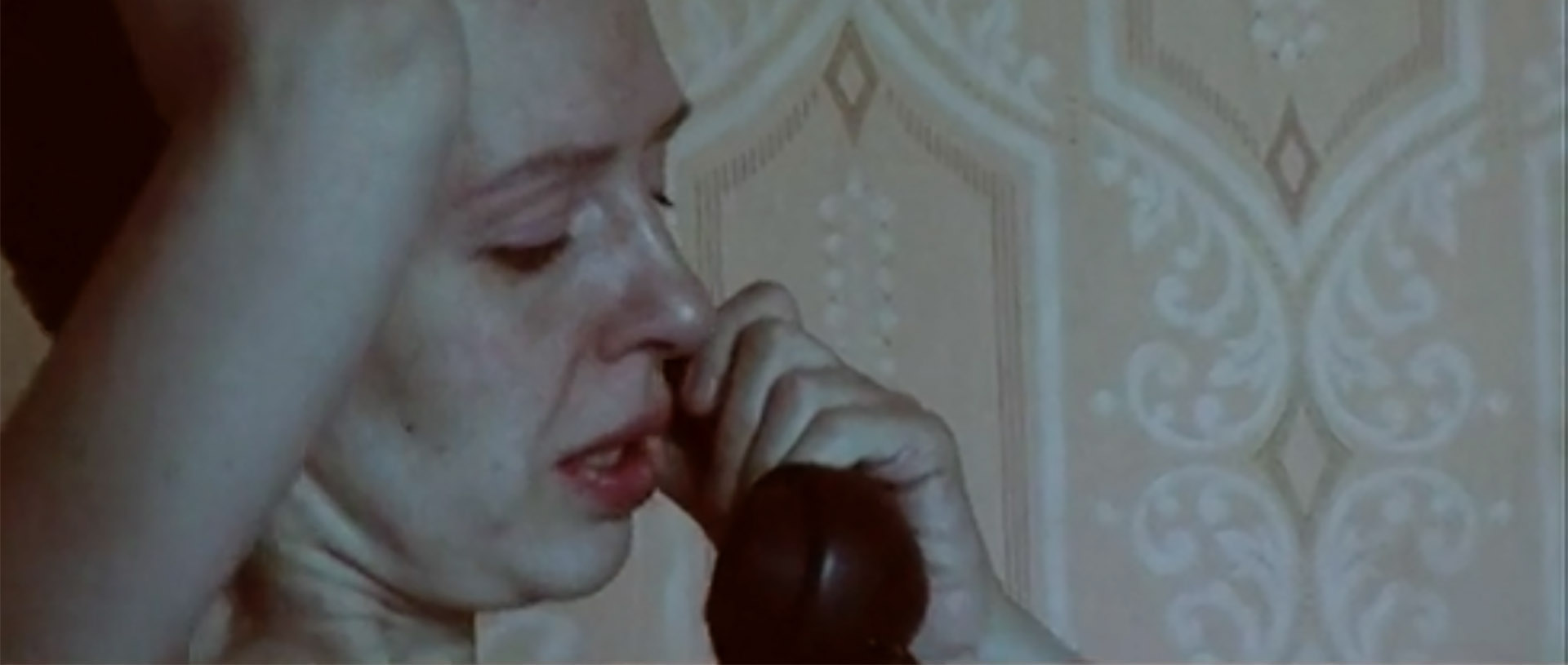 A woman talks on the phone in the documentary Outro